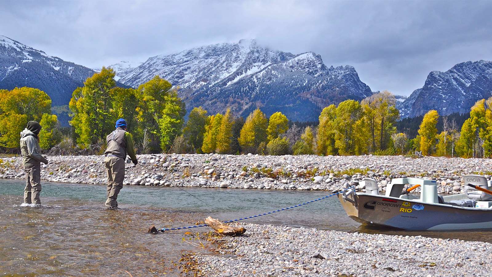 Jackson Hole Fly Fishing snake river with snowy mountains in the background
