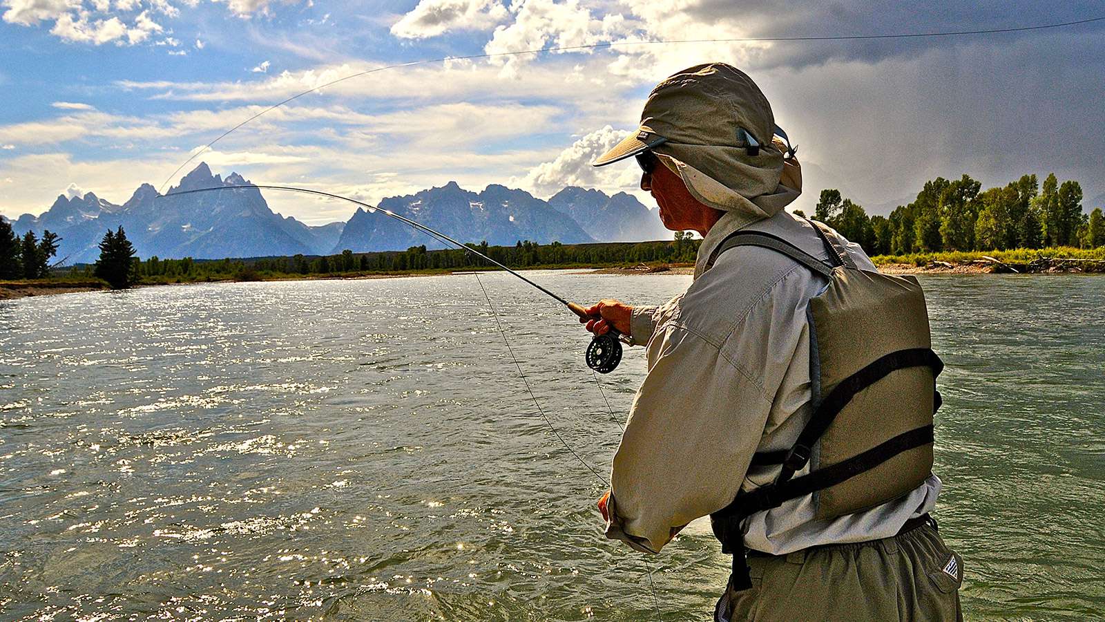 Jackson Hole Fishing Trips angler casting into the snake river from the shore