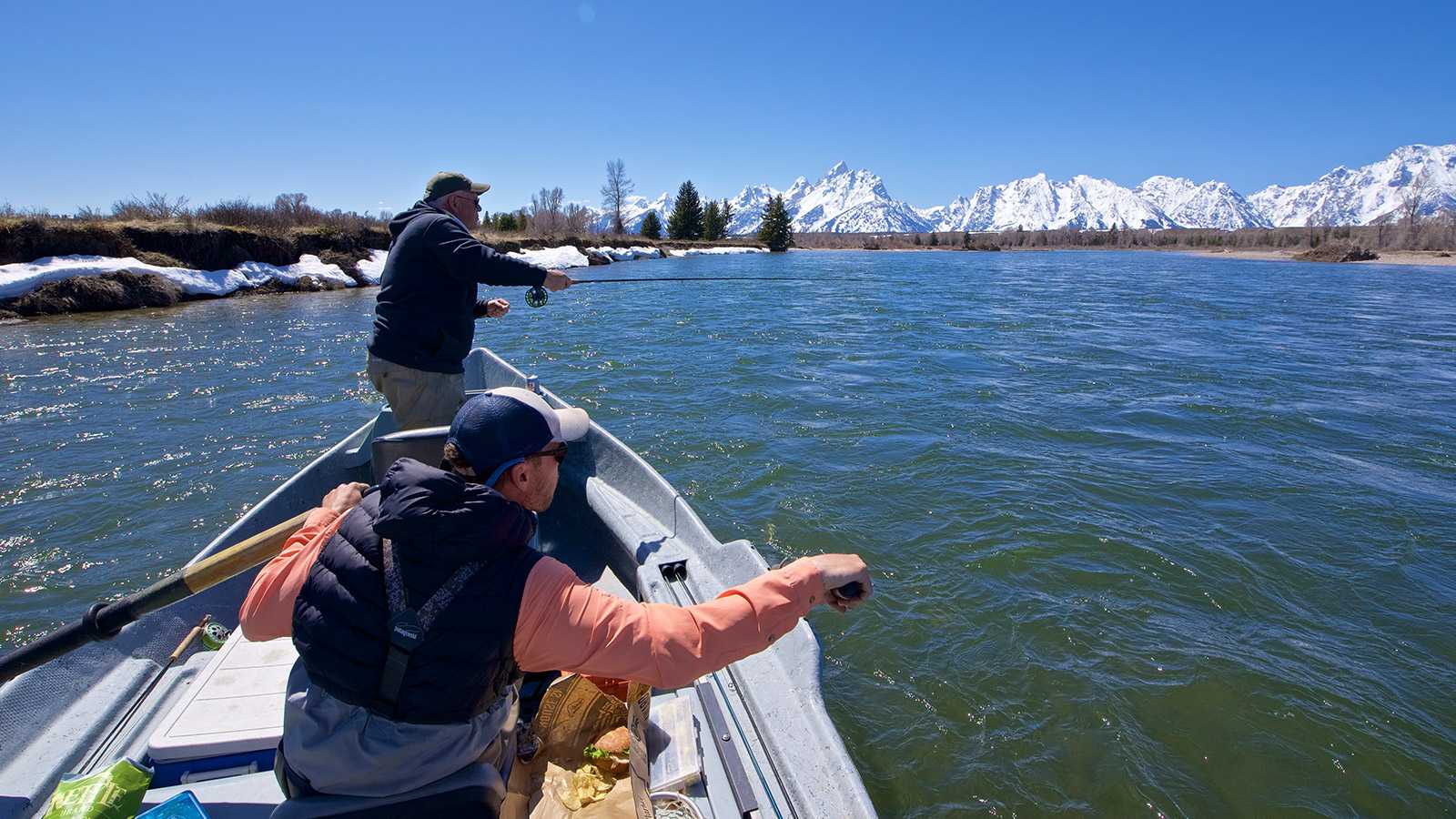 Jackson Hole Half Day Fly Fishing Trips guide rowing and client casting from boat into snake river