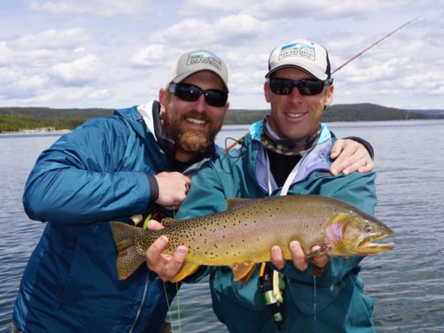 yellowstone lake fishing guides with client and big trout